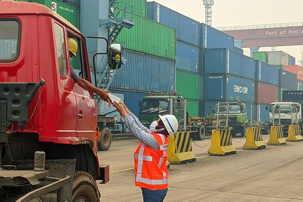 Tim IPC TPK Pontianak membagikan masker dan makanan ringan kepada pengemudi truk yang beroperasi di IPC TPK Pontianak